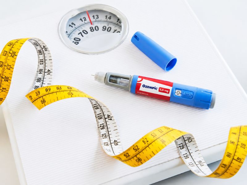 Ozempic pen with weighing scale and measuring tape for weight loss